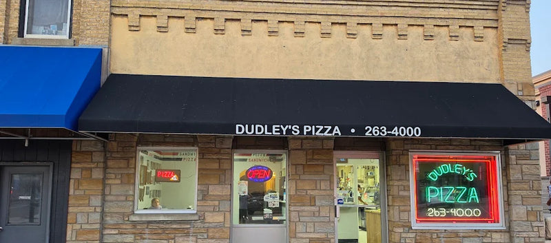 Dudley's Pizza storefront with a black awning on Mill Street in Cannon Falls, MN